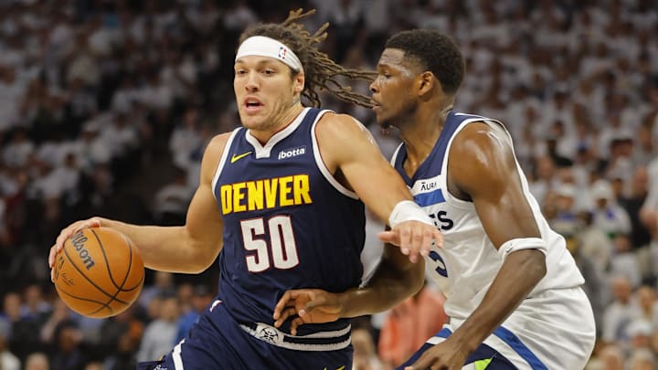 May 12, 2024; Minneapolis, Minnesota, USA; Denver Nuggets forward Aaron Gordon (50) works around Minnesota Timberwolves guard Anthony Edwards (5) in the first quarter of game four of the second round for the 2024 NBA playoffs at Target Center.