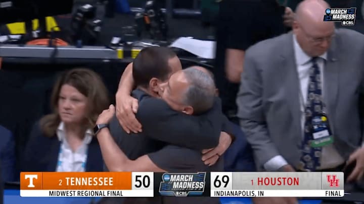Houston head coach Kelvin Sampson and assistant Kellen Sampson embrace after win over Tennessee in Elite Eight.