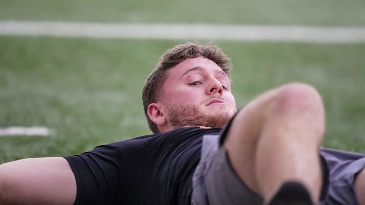 Former Longhorns Quinn Ewers stretches and warms up during Texas' Pro Day at the Texas Football Training Facility on Tuesday, March 25, 2025.
