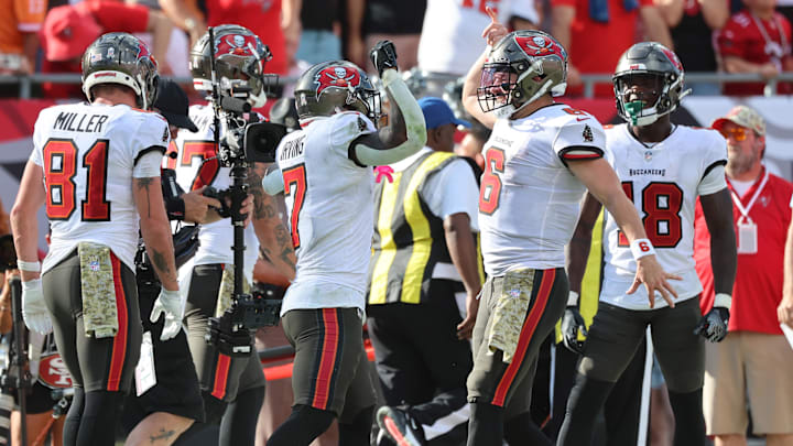 Nov 10, 2024; Tampa, Florida, USA; Tampa Bay Buccaneers running back Bucky Irving (7)  is congratulated  by quarterback Baker Mayfield (6) after he scored  a touchdown against the San Francisco 49ers during the second half at Raymond James Stadium. Mandatory Credit: Kim Klement Neitzel-Imagn Images