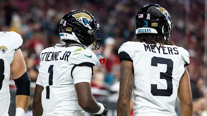 Nov 23, 2025; Glendale, Arizona, USA; Jacksonville Jaguars running back Travis Etienne Jr. (1) with wide receiver Jakobi Meyers (3) against the Arizona Cardinals at State Farm Stadium. Mandatory Credit: Mark J. Rebilas-Imagn Images