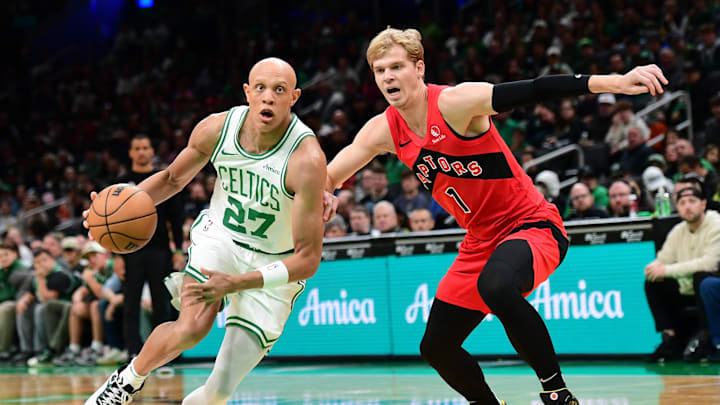 Oct 13, 2024; Boston, Massachusetts, USA;  Boston Celtics guard Jordan Walsh (27) drives to the basket past Toronto Raptors guard Gradey Dick (1) during the first half at TD Garden. Mandatory Credit: Bob DeChiara-Imagn Images