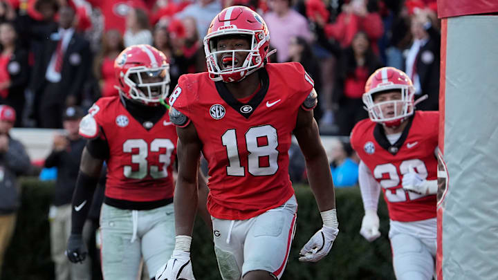 Georgia linebacker Chris Cole (18) celebrates with his teammates after scoring touchdown during the second half of a NCAA college football game against Massachusetts in Athens, Ga., on Saturday, Nov. 23, 2024.