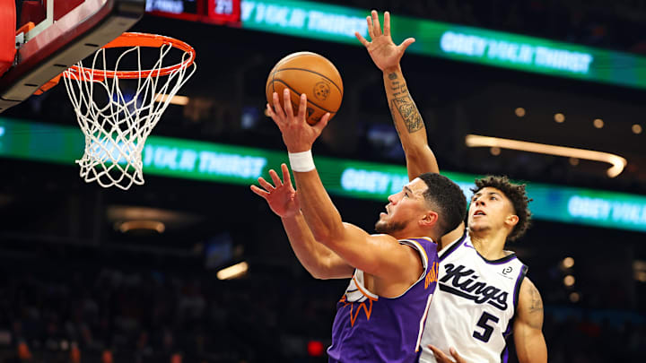 Oct 22, 2025; Phoenix, Arizona, USA; Phoenix Suns guard Devin Booker (1) shoots the ball against Sacramento Kings guard Nique Clifford (5) during the first quarter at Mortgage Matchup Center. Mandatory Credit: Mark J. Rebilas-Imagn Images Oct 22, 2025; Phoenix, Arizona, USA; Phoenix Suns guard Devin Booker (1) shoots the ball against Sacramento Kings guard Nique Clifford (5) during the first quarter at Mortgage Matchup Center. Mandatory Credit: Mark J. Rebilas-Imagn Images