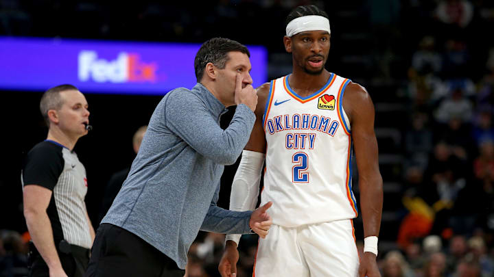Nov 9, 2025; Memphis, Tennessee, USA; Oklahoma City Thunder head coach Mark Daigneault talks with guard Shai Gilgeous-Alexander (2) during the third quarter against the Memphis Grizzlies at FedExForum. Mandatory Credit: Petre Thomas-Imagn Images Nov 9, 2025; Memphis, Tennessee, USA; Oklahoma City Thunder head coach Mark Daigneault talks with guard Shai Gilgeous-Alexander (2) during the third quarter against the Memphis Grizzlies at FedExForum. Mandatory Credit: Petre Thomas-Imagn Images