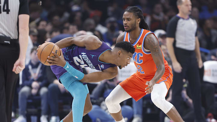Feb 2, 2024; Oklahoma City, Oklahoma, USA; Charlotte Hornets forward Brandon Miller (24) moves the ball against Oklahoma City Thunder guard Cason Wallace (22) during the first quarter at Paycom Center. Mandatory Credit: Alonzo Adams-Imagn Images