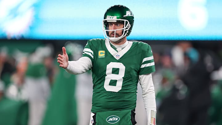 Jan 5, 2025; East Rutherford, New Jersey, USA; New York Jets quarterback Aaron Rodgers (8) gestures towards the Miami Dolphins bench during the second half at MetLife Stadium. Mandatory Credit: Vincent Carchietta-Imagn Images