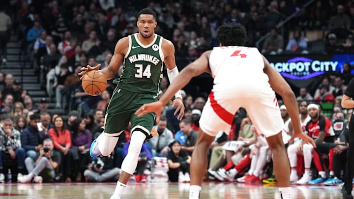 Jan 6, 2025; Toronto, Ontario, CAN; Milwaukee Bucks forward Giannis Antetokounmpo (34) dribbles the ball as Toronto Raptors forward Scottie Barnes (4) defends during the second quarter at Scotiabank Arena. Mandatory Credit: Nick Turchiaro-Imagn Images