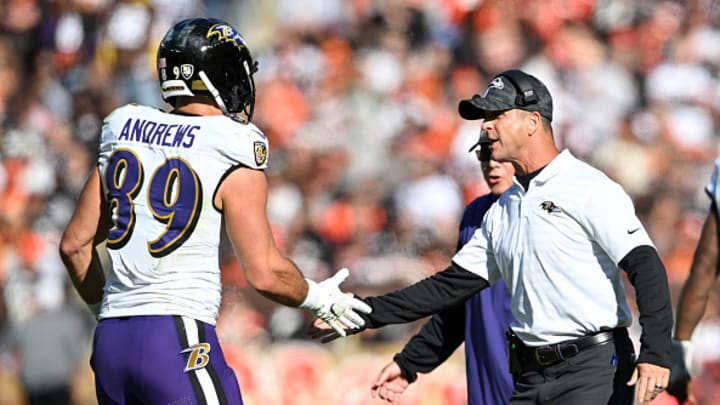 Harbaugh celebrating with Andrews after a touchdown reception during an October game. 