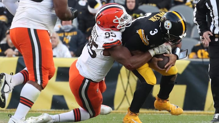 Dec 8, 2024; Pittsburgh, Pennsylvania, USA;  Cleveland Browns defensive end Myles Garrett (95) sacks Pittsburgh Steelers quarterback Russell Wilson (3) during the fourth quarter at Acrisure Stadium. Mandatory Credit: Charles LeClaire-Imagn Images