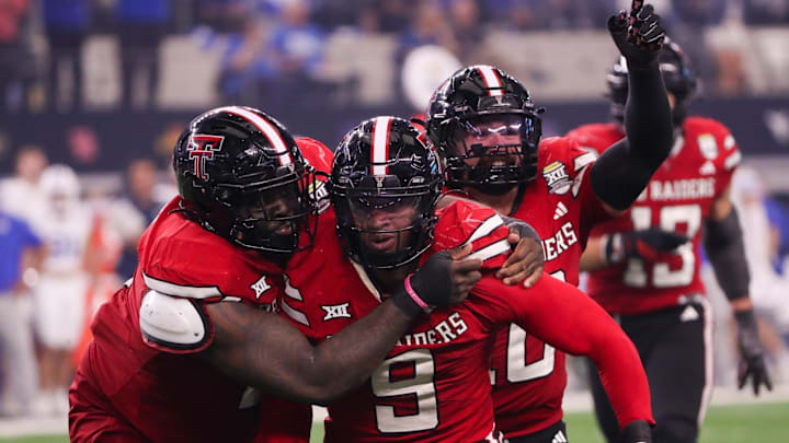 Texas Tech players Lee Hunter (left) and Jacob Rodriguez (back) celebrate Romello Height's fumble recover against BYU during the Big 12 Conference championship football game, Saturday, Nov. 6, 2025, at AT&T Stadium in Arlington.