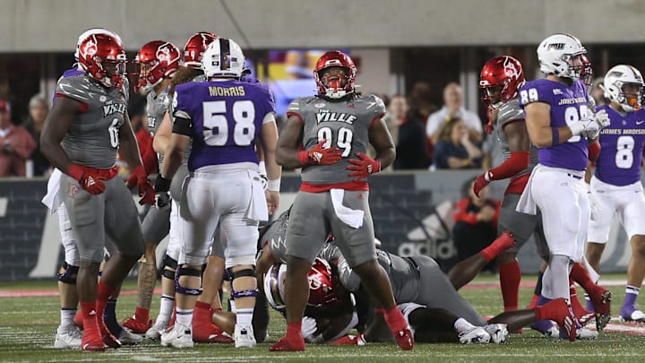 Louisville's Dezmond Tell (99) celebrates a great defensive play against James Madison