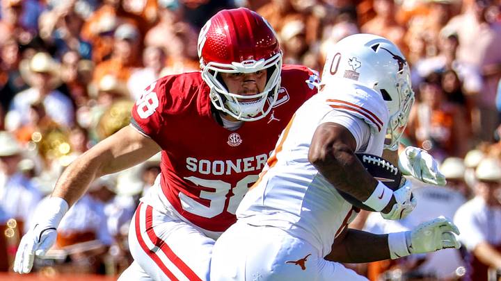 Oklahoma linebacker Owen Heinecke tackles Texas running back Raleek Brown. Oklahoma linebacker Owen Heinecke tackles Texas running back Raleek Brown.