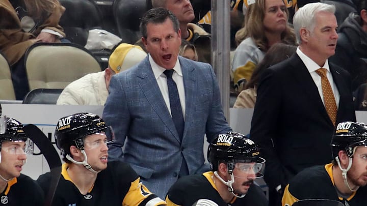 Nov 30, 2024; Pittsburgh, Pennsylvania, USA;  Pittsburgh Penguins head coach Mike Sullivan (rear) reacts on the bench against the Calgary Flames during the third period  at PPG Paints Arena. Mandatory Credit: Charles LeClaire-Imagn Images