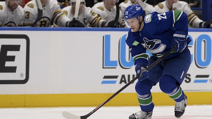 Feb 24, 2024; Vancouver, British Columbia, CAN;   Vancouver Canucks forward Elias Lindholm (23) skates with the puck during a game against the Boston Bruins in Vancouver