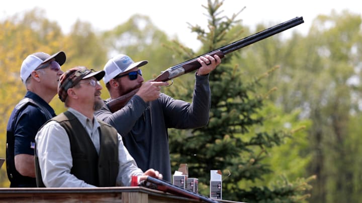 (L to R) Pat Lieske, 58 of Davison, and David Olshansky, 53, of Walled Lake, look on as Frank Ragnow, of the Detroit Lions, competes against Olshansky during Ragnow's Skeet Shoot Showdown competition at the Michigan Shooting Center at Bald Mountain in Lake Orion, Thursday, May 18, 2023.