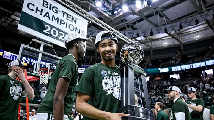 Michigan State's Jaden Akins holds the Big Ten championship trophy after the game against Michigan on Sunday, March 9, 2025, at the Breslin Center in East Lansing.