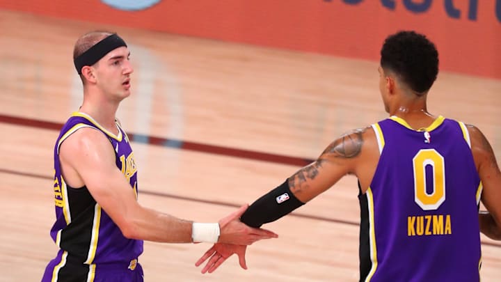 Sep 26, 2020; Lake Buena Vista, Florida, USA; Los Angeles Lakers guard Alex Caruso (4) celebrates with forward Kyle Kuzma (0) after scoring a basket while being fouled by the Denver Nuggets during the first half in game five of the Western Conference Finals of the 2020 NBA Playoffs at AdventHealth Arena. Mandatory Credit: Kim Klement-USA TODAY Sports