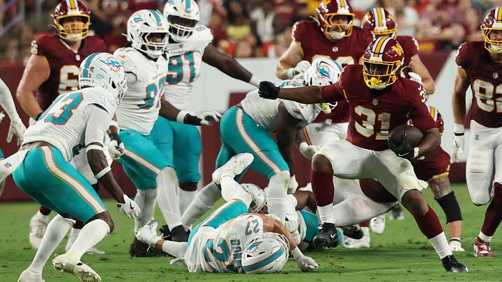 Aug 14, 2026; Landover, Maryland, USA; Washington Commanders running back Kaytron Allen (31) carries the ball as Miami Dolphins safety Major Burns (43) and Dolphins cornerback Ethan Bonner (27) defend during the first half at Northwest Stadium. Mandatory Credit: Geoff Burke-Imagn Images