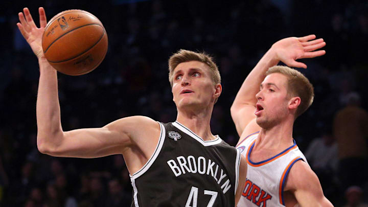 Nov 7, 2014; Brooklyn, NY, USA; Brooklyn Nets small forward Andrei Kirilenko (47) grabs a rebound in front of New York Knicks small forward Travis Wear (6) during the fourth quarter at Barclays Center. The Nets defeated the Knicks 110-99. Mandatory Credit: Brad Penner-Imagn Images