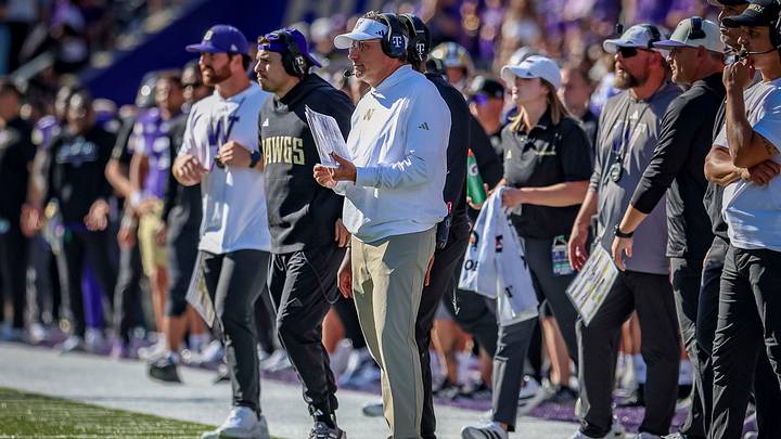 Jedd Fisch works the sideline as the UW offensive coordinator with his play sheet. Jedd Fisch works the sideline as the UW offensive coordinator with his play sheet.