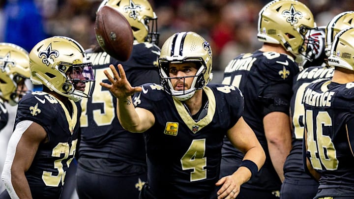 Nov 10, 2024; New Orleans, Louisiana, USA;   New Orleans Saints quarterback Derek Carr (4) tosses the ball to the referee against the Atlanta Falcons during the first half at Caesars Superdome. Mandatory Credit: Stephen Lew-Imagn Images