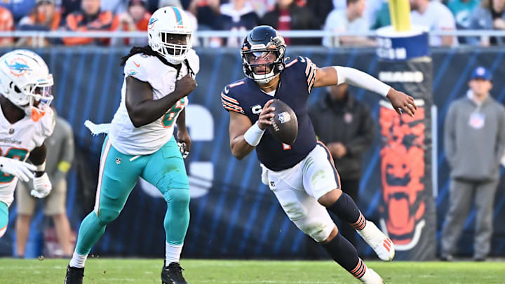 Chicago Bears quarterback Justin Fields (1) controls the ball against the Miami Dolphins at Soldier Field. Chicago Bears quarterback Justin Fields (1) controls the ball against the Miami Dolphins at Soldier Field.