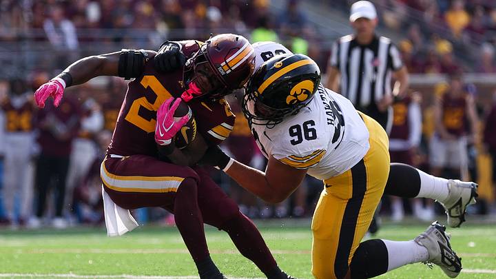 Oct 24, 2026; Minneapolis, Minnesota, USA; Iowa Hawkeyes defensive lineman Bryce Hawthorne (96) tackles Minnesota Golden Gophers running back TJ Thomas (23) during the first half at Huntington Bank Stadium. Mandatory Credit: Matt Krohn-Imagn Images