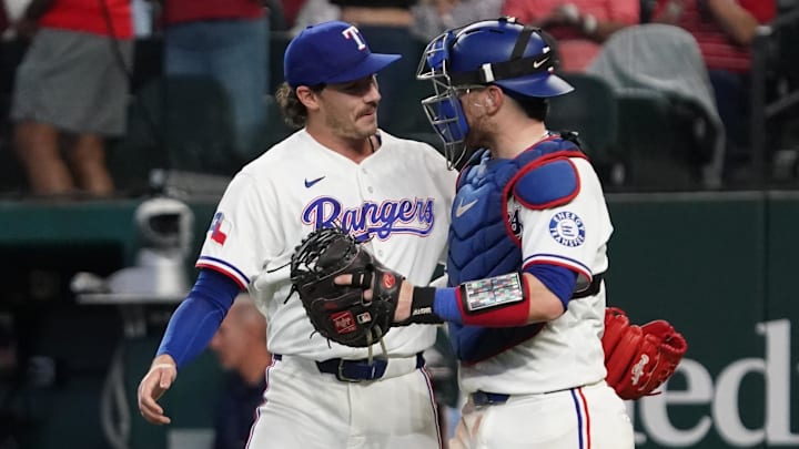 Texas Rangers pitcher Cole Winn and catcher Danny Jansen celebrate a win. 