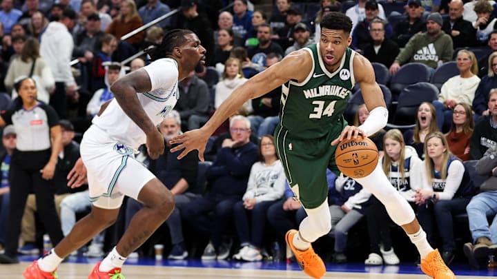 Feb 23, 2024; Minneapolis, Minnesota, USA; Milwaukee Bucks forward Giannis Antetokounmpo (34) works around Minnesota Timberwolves center Naz Reid (11) during the first half at Target Center.