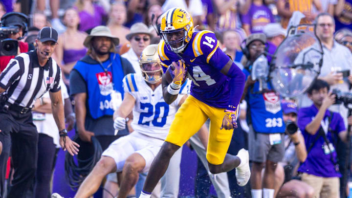 Sep 21, 2024; Baton Rouge, Louisiana, USA;  LSU Tigers tight end Trey'Dez Green (14) runs after a catch against the UCLA Bruins during the second half at Tiger Stadium. Mandatory Credit: Stephen Lew-Imagn Images