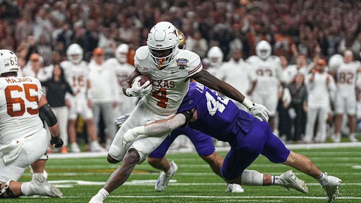 Texas Longhorns running back CJ Baxter (4) is tackled by Washington linebacker Carson Bruener (42) during the Sugar Bowl College Football Playoff semifinals game at the Caesars Superdome on Monday, Jan. 1, 2024 in New Orleans, Louisiana. Texas Longhorns running back CJ Baxter (4) is tackled by Washington linebacker Carson Bruener (42) during the Sugar Bowl College Football Playoff semifinals game at the Caesars Superdome on Monday, Jan. 1, 2024 in New Orleans, Louisiana.