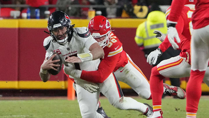Jan 18, 2025; Kansas City, Missouri, USA; Houston Texans quarterback C.J. Stroud (7) is sacked by Kansas City Chiefs defensive end George Karlaftis (56) during the fourth quarter of a 2025 AFC divisional round game at GEHA Field at Arrowhead Stadium. Mandatory Credit: Denny Medley-Imagn Images