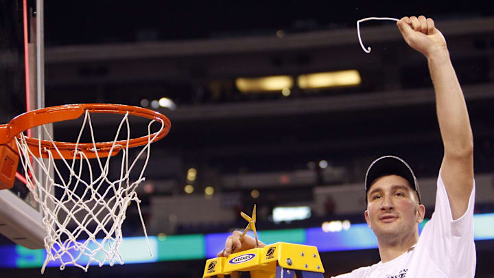Mar 29, 2009; Indianapolis, IN, USA; Michigan State Spartans center Goran Suton (14) waves to the crowd after cutting down a piece of the net after defeating the Louisville Cardinals 64-52 in the finals of the midwest region of the 2009 NCAA mens basketball tournament at Lucas Oil Stadium.  Mandatory Credit: Jerry Lai-Imagn Images