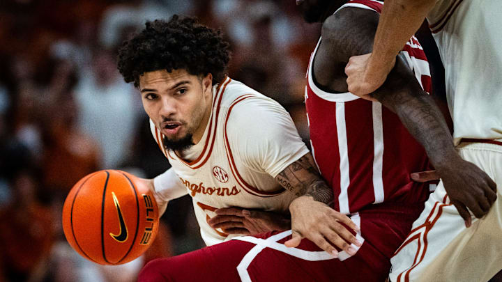 Texas Longhorns guard Jordan Pope (0) pushes past Oklahoma defense in the first half of the Longhorns' game against the Oklahoma Sooners at the Moody Center in Austin, March 8, 2025.