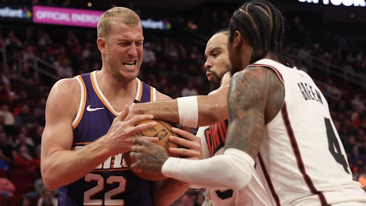 Feb 12, 2025; Houston, Texas, USA; Phoenix Suns center Mason Plumlee (22) and Houston Rockets forward Dillon Brooks (9) and  guard Jalen Green (4) fight over a rebound in the second quarter at Toyota Center. Mandatory Credit: Thomas Shea-Imagn Images