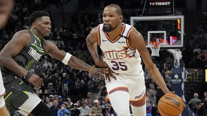Mar 28, 2025; Minneapolis, Minnesota, USA; Phoenix Suns forward Kevin Durant (35) brings the ball up as Minnesota Timberwolves guard Anthony Edwards (5) defends him in the fourth quarter at Target Center. Mandatory Credit: Bruce Kluckhohn-Imagn Images