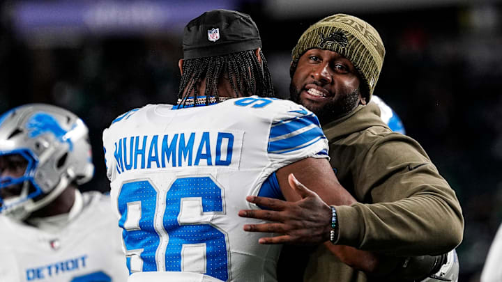Detroit Lions defensive coordinator Kelvin Sheppard hugs linebacker Al-Quadin Muhammad (96) at warmup ahead of the Philadelphia Eagles game at Lincoln Financial Field in Philadelphia on Sunday, November 16, 2025.