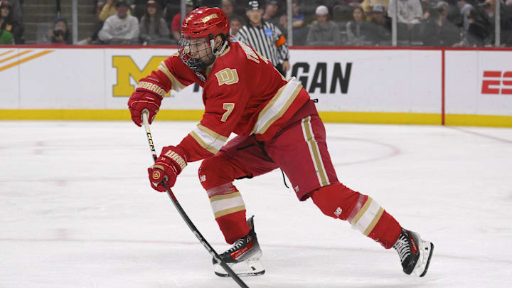 Apr 13, 2024; Saint Paul, Minnesota, USA; Denver Pioneers forward Aidan Thompson (7) makes a pass against the Boston College Eagles during the first period of the championship game of the 2024 Frozen Four college ice hockey tournament at Xcel Energy Center. Mandatory Credit: Nick Wosika-Imagn Images