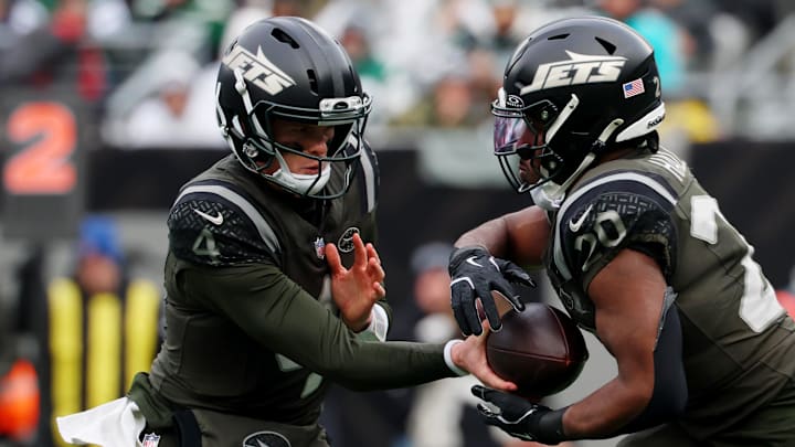 Dec 7, 2025; East Rutherford, New Jersey, USA; New York Jets quarterback Brady Cook (4) hands the ball off to running back Breece Hall (20) during the first half at MetLife Stadium. Mandatory Credit: Ed Mulholland-Imagn Images