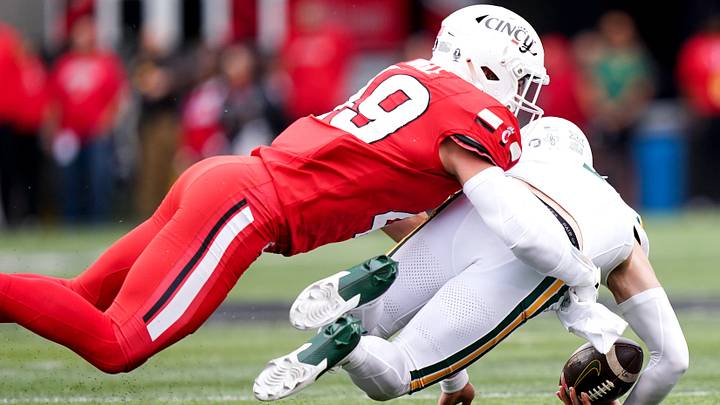 Cincinnati Bearcats linebacker Jack Dingle (49) tackles Baylor Bears quarterback Sawyer Robertson. Cincinnati Bearcats linebacker Jack Dingle (49) tackles Baylor Bears quarterback Sawyer Robertson.
