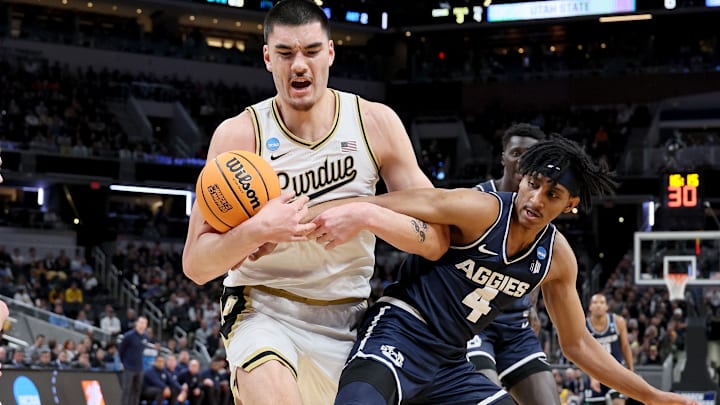 Utah State guard Ian Martinez battling with Purdue center Zach Edey