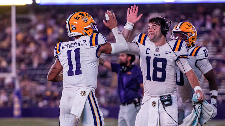 Sep 20, 2025; Baton Rouge, Louisiana, USA; LSU Tigers quarterback Garrett Nussmeier (18) congratulates LSU Tigers quarterback Michael Van Buren Jr. (11) on a touchdown run against the Southeastern Louisiana Lions during the second half at Tiger Stadium. Mandatory Credit: Stephen Lew-Imagn Images Sep 20, 2025; Baton Rouge, Louisiana, USA; LSU Tigers quarterback Garrett Nussmeier (18) congratulates LSU Tigers quarterback Michael Van Buren Jr. (11) on a touchdown run against the Southeastern Louisiana Lions during the second half at Tiger Stadium. Mandatory Credit: Stephen Lew-Imagn Images