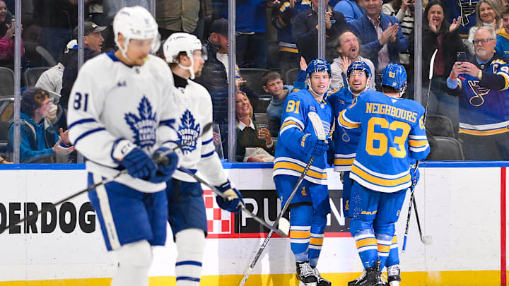 Mar 28, 2026; St. Louis, Missouri, USA; St. Louis Blues left wing Dylan Holloway (81) is congratulated by right wing Jordan Kyrou (25) and left wing Jake Neighbours (63) after scoring against the Toronto Maple Leafs during the third period at Enterprise Center. Mandatory Credit: Jeff Curry-Imagn Images