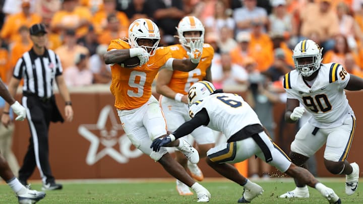 Sep 6, 2025; Knoxville, Tennessee, USA; Tennessee Volunteers running back Star Thomas (9) runs with the ball against East Tennessee State Buccaneers defensive back Jivon Oggs (6) during the second quarter at Neyland Stadium. Mandatory Credit: Randy Sartin-Imagn Images