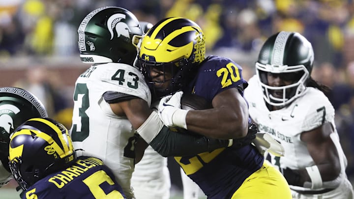 Oct 26, 2024; Ann Arbor, Michigan, USA;  Michigan Wolverines running back Kalel Mullings (20) is tackled by Michigan State Spartans defensive back Malik Spencer (43) in the first half at Michigan Stadium. Mandatory Credit: Rick Osentoski-Imagn Images
