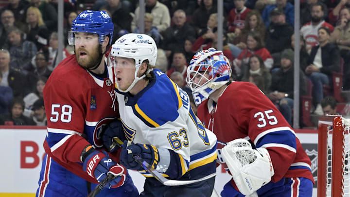 Oct 26, 2024; Montreal, Quebec, CAN; Montreal Canadiens defenseman David Savard (58) moves St.Louis Blues forward Jake Neighbours (63) away from screening  Montreal goalie Sam Montembeault (35) during the second period at the Bell Centre. Mandatory Credit: Eric Bolte-Imagn Images
