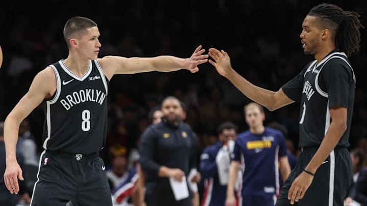 Jan 4, 2026; Brooklyn, New York, USA;  Brooklyn Nets guard Egor Demin (8) greets forward Ziaire Williams (1) during a timeout in the third quarter against the Denver Nuggets at Barclays Center. Mandatory Credit: Wendell Cruz-Imagn Images