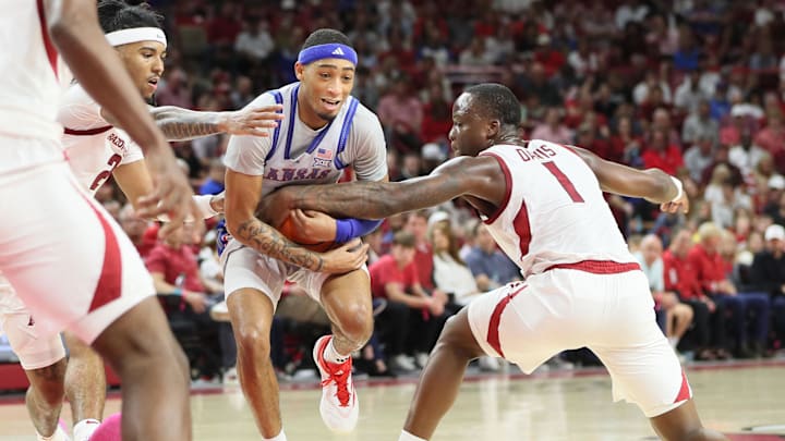 Arkansas Razorbacks guard Johnell Davis (1) plays aggressive help defense as Kansas Jayhawks guard Dajuan Harris Jr (3) drives to the paint in the second quarter before a sellout crowd at Friday night's exhibition game in Bud Walton Arena. Hogs first-year coach John Calipari enjoyed an impressive beginning to his tenure with the 85-69 win against the Jayhawks, led by fellow Hall of Fame coach Bill Self. 
