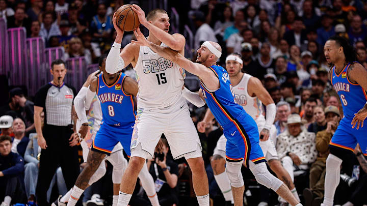 May 15, 2025; Denver, Colorado, USA; Denver Nuggets center Nikola Jokic (15) controls the ball under pressure form Oklahoma City Thunder guard Alex Caruso (9) in the second quarter during game six of the second round for the 2025 NBA Playoffs at Ball Arena. Mandatory Credit: Isaiah J. Downing-Imagn Images